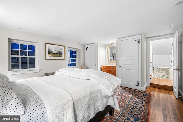 bedroom featuring recessed lighting, dark wood-style flooring, and baseboards