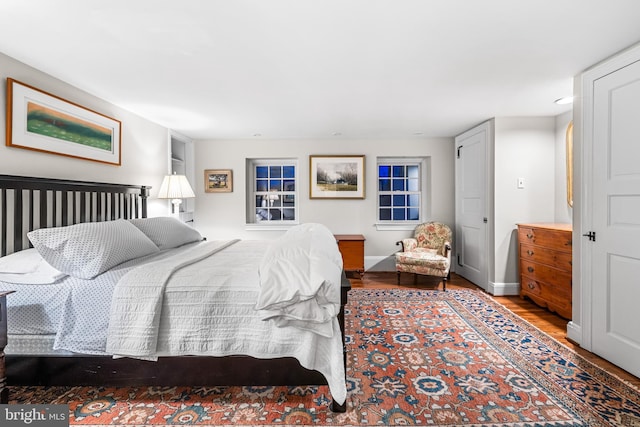 bedroom with wood finished floors and baseboards