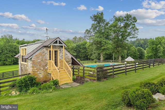 exterior space with fence, a fenced in pool, and a lawn