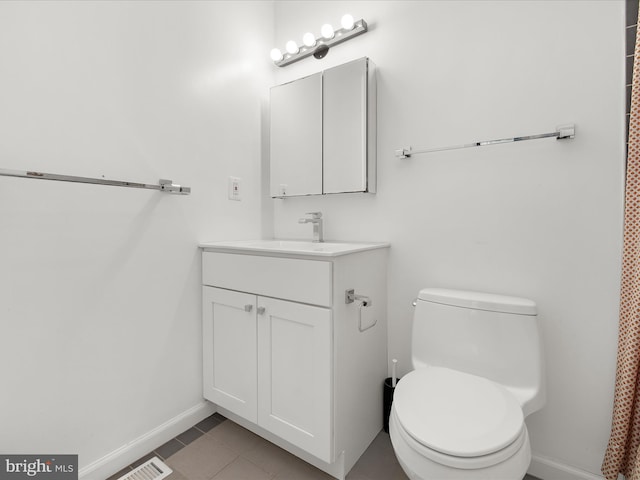 full bath with baseboards, vanity, toilet, and tile patterned floors
