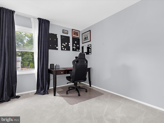 carpeted home office with baseboards