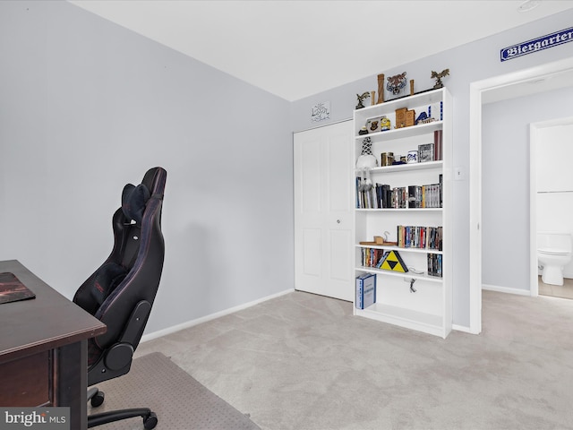 carpeted home office with baseboards