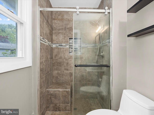 full bath featuring toilet and a stall shower