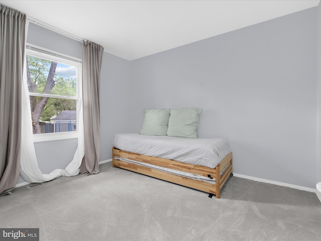 carpeted bedroom with baseboards