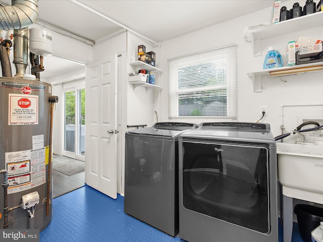 laundry area featuring gas water heater and washer and dryer