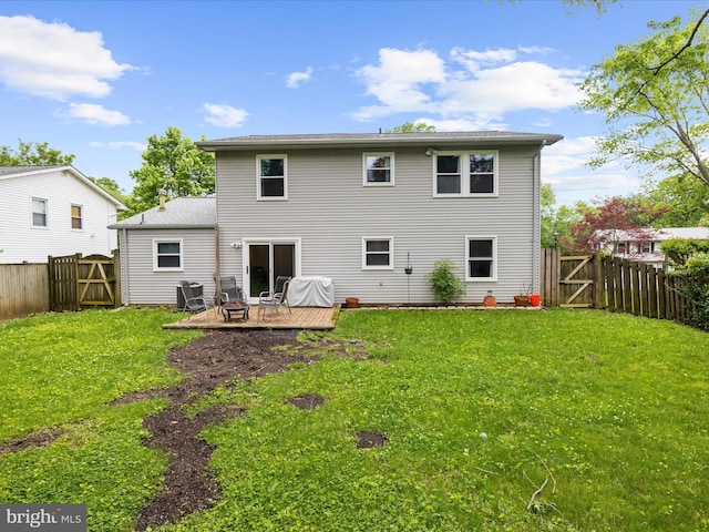 rear view of house featuring a gate and a fire pit