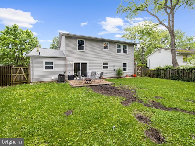 back of property with a fire pit, a gate, and a patio area