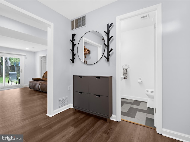 entrance foyer with dark wood-type flooring and baseboards
