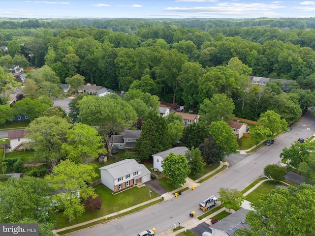 aerial view of residential area with a heavily wooded area