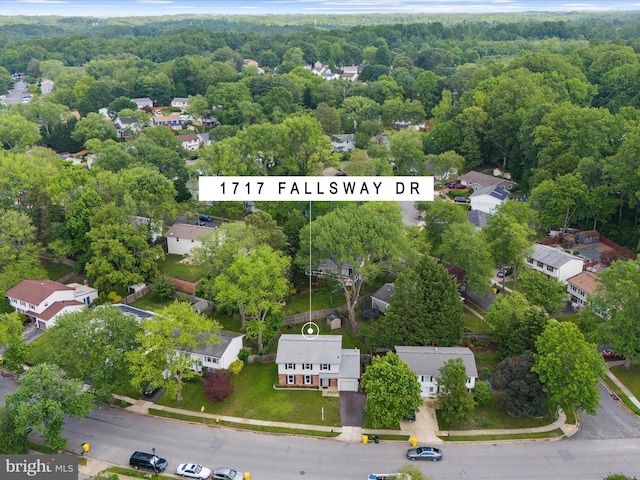 aerial perspective of suburban area with a heavily wooded area