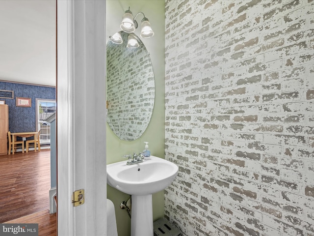 200 Rubens Cir, Martinsburg, WV 25403 - bathroom featuring an inviting chandelier, a sink, wallpapered walls, and wood finished floors
