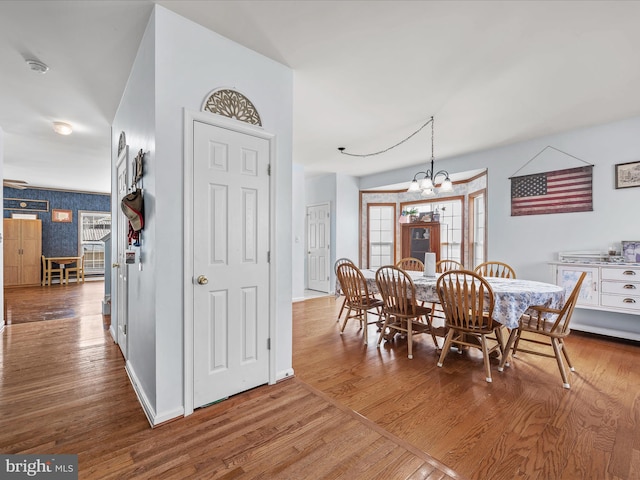 200 Rubens Cir, Martinsburg, WV 25403 - dining area with a chandelier, baseboards, wallpapered walls, and wood finished floors