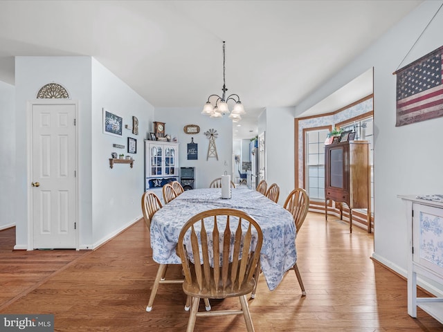 200 Rubens Cir, Martinsburg, WV 25403 - dining area with a chandelier, light wood-style floors, and baseboards