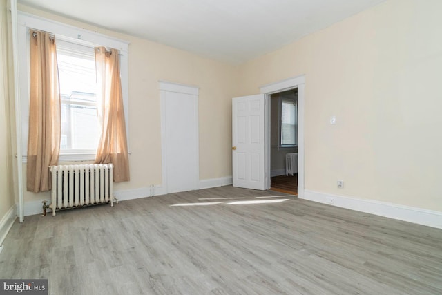 2607 Quantico Ave, Baltimore, MD 21215 - spare room with baseboards, radiator heating unit, and wood finished floors