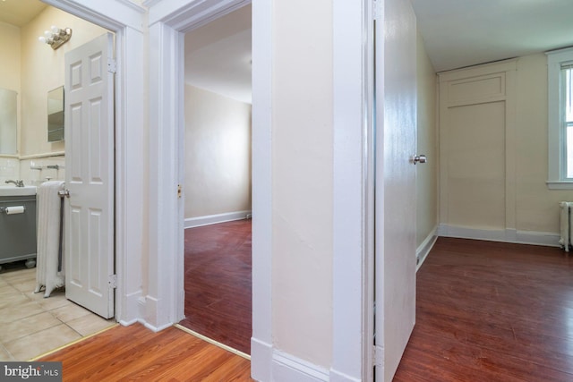 2607 Quantico Ave, Baltimore, MD 21215 - hallway with a sink, radiator, baseboards, and wood finished floors