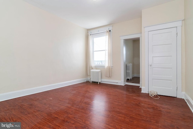 2607 Quantico Ave, Baltimore, MD 21215 - unfurnished bedroom featuring radiator, baseboards, and wood finished floors