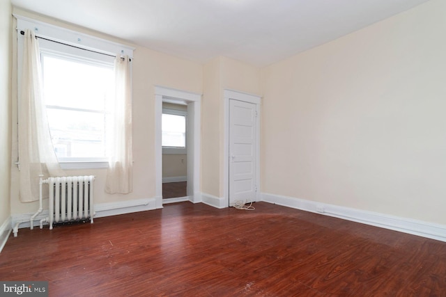 2607 Quantico Ave, Baltimore, MD 21215 - unfurnished room featuring radiator heating unit, baseboards, and wood finished floors
