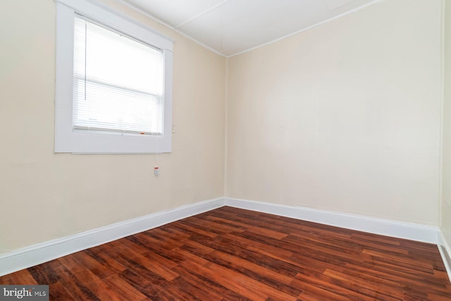 2607 Quantico Ave, Baltimore, MD 21215 - empty room featuring crown molding, baseboards, and dark wood-style flooring