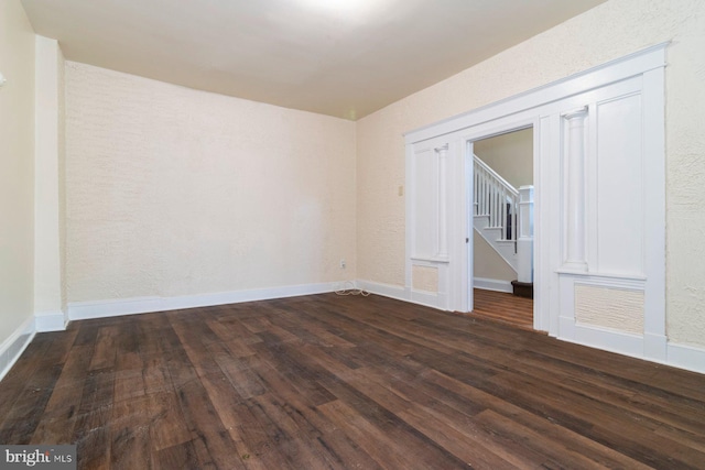 2607 Quantico Ave, Baltimore, MD 21215 - unfurnished room featuring stairs, baseboards, and wood finished floors