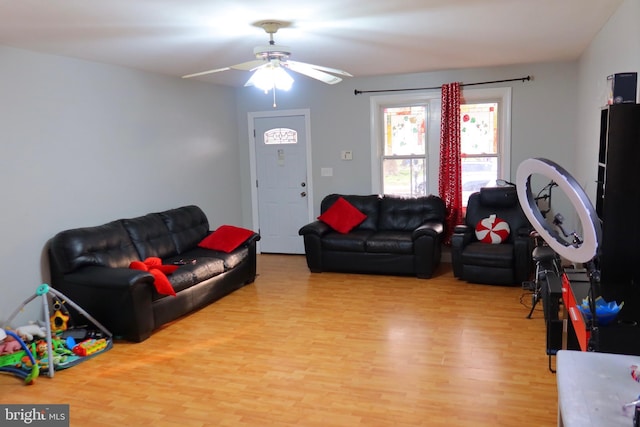 living area with light wood-type flooring and ceiling fan