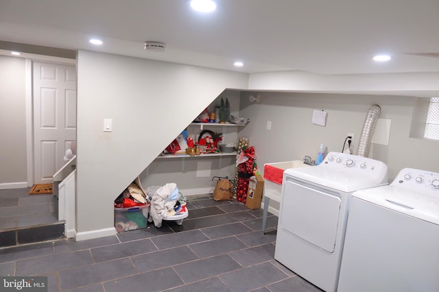 laundry area with recessed lighting, separate washer and dryer, laundry area, and dark tile patterned flooring