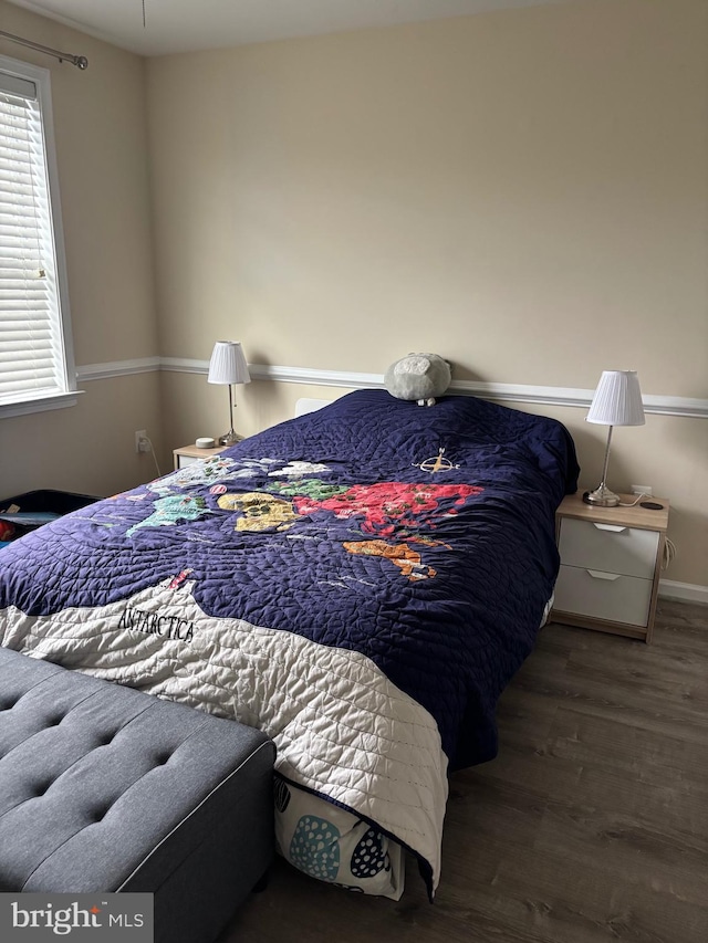 bedroom featuring baseboards and wood finished floors