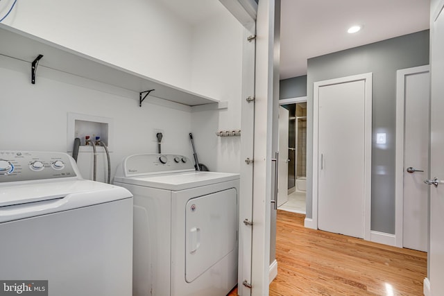 817 57th Pl, Fairmount Heights, MD 20743 - laundry area with light wood-type flooring and separate washer and dryer