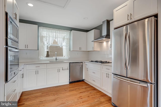 817 57th Pl, Fairmount Heights, MD 20743 - kitchen featuring a sink, wall chimney exhaust hood, appliances with stainless steel finishes, and light countertops