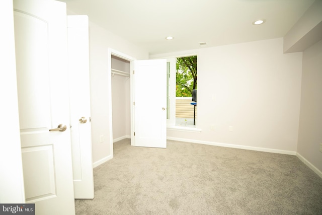 unfurnished bedroom featuring baseboards, recessed lighting, and carpet