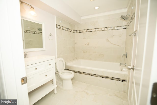 bathroom with toilet, tiled shower / bath, vanity, and recessed lighting