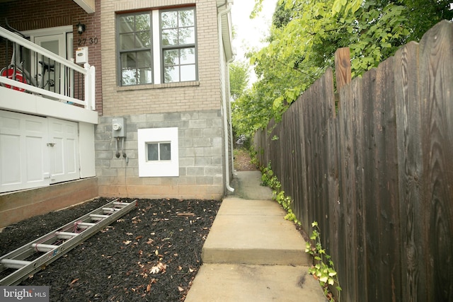 exterior space with brick siding and fence