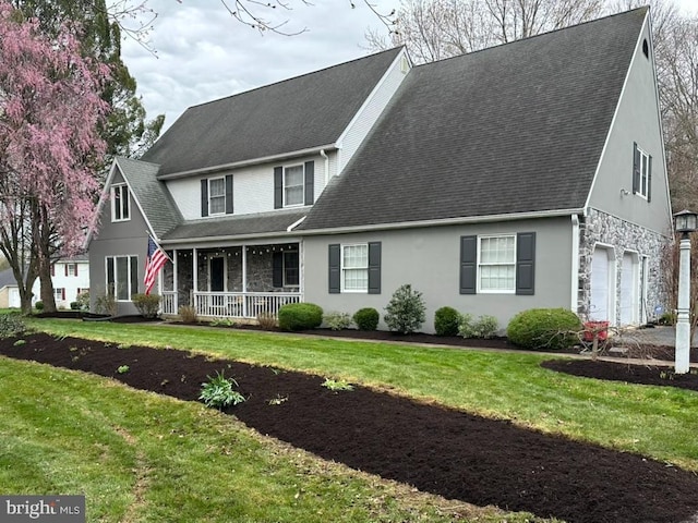 510 Greenhowe Dr, Lititz, PA 17543 - view of front facade with covered porch, a front yard, stone siding, roof with shingles, and an attached garage