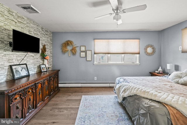 213 Stump Rd, North Wales, PA 19454 - bedroom featuring visible vents, a baseboard radiator, a ceiling fan, and wood finished floors