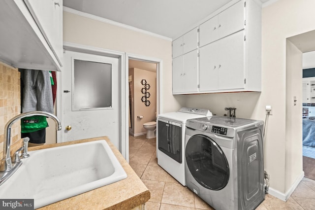 213 Stump Rd, North Wales, PA 19454 - laundry area with ornamental molding, light tile patterned flooring, separate washer and dryer, a sink, and cabinet space