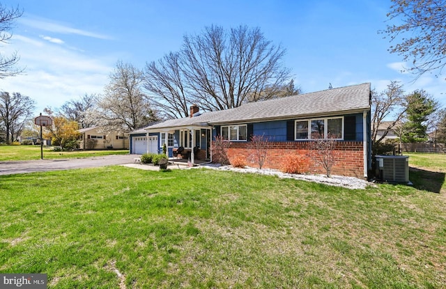 213 Stump Rd, North Wales, PA 19454 - single story home featuring a front yard, a garage, central air condition unit, brick siding, and aphalt driveway
