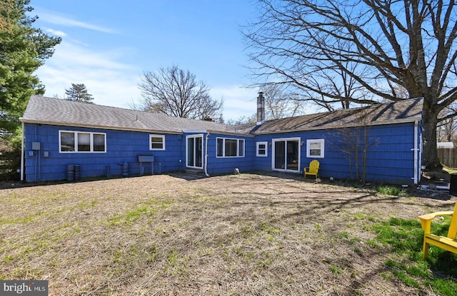 213 Stump Rd, North Wales, PA 19454 - back of house with a shingled roof and a chimney