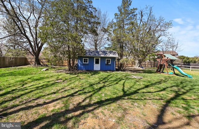 213 Stump Rd, North Wales, PA 19454 - view of yard featuring an outdoor structure, a fenced backyard, a playground, and a storage unit