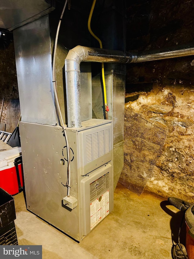 utility room featuring heating unit