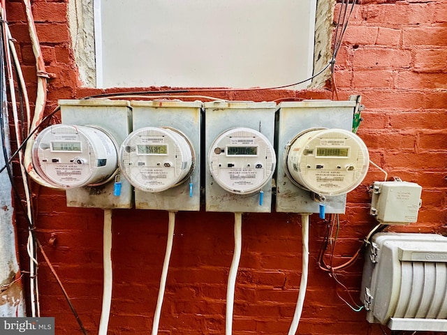 details with electric meter and brick siding