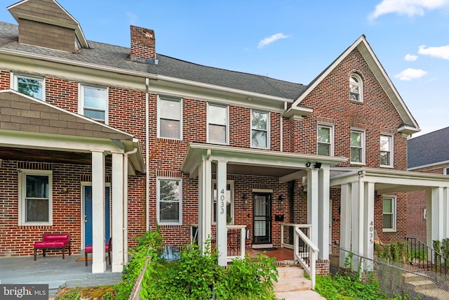 4033 Woodhaven Ave, Baltimore, MD 21216 - multi unit property featuring brick siding, a chimney, and covered porch