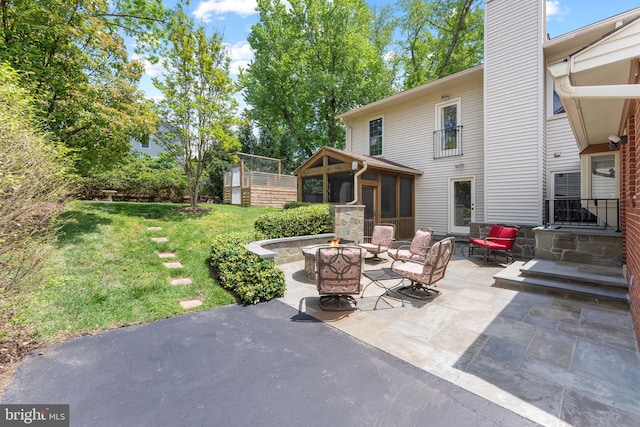 1823 Westmoreland St, Mclean, VA 22101 - view of patio with an outdoor fire pit and a sunroom