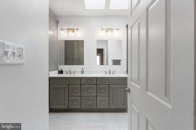 1823 Westmoreland St, Mclean, VA 22101 - full bath with tile patterned floors, double vanity, and a skylight