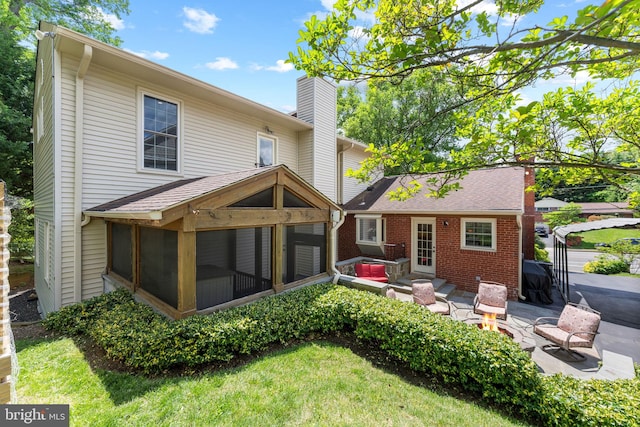 1823 Westmoreland St, Mclean, VA 22101 - back of property with a sunroom, a patio, a chimney, brick siding, and an outdoor hangout area