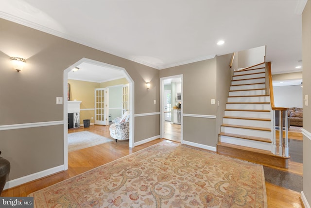 1823 Westmoreland St, Mclean, VA 22101 - entryway with wood finished floors, stairs, baseboards, crown molding, and arched walkways