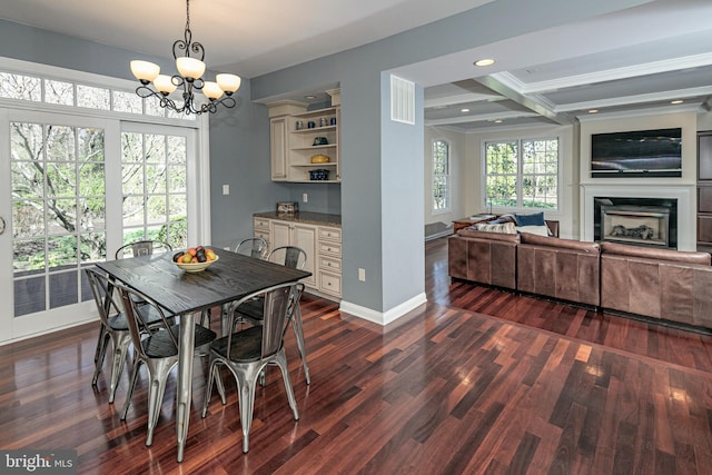 dining space featuring baseboards, an inviting chandelier, recessed lighting, a fireplace, and dark wood finished floors