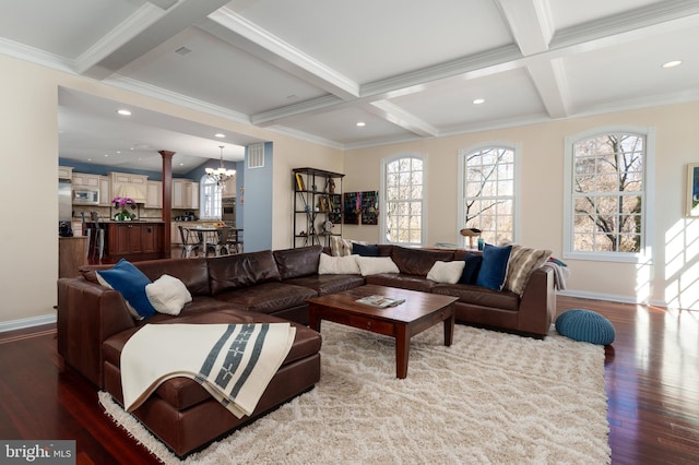 living area with coffered ceiling, beam ceiling, a chandelier, and a healthy amount of sunlight
