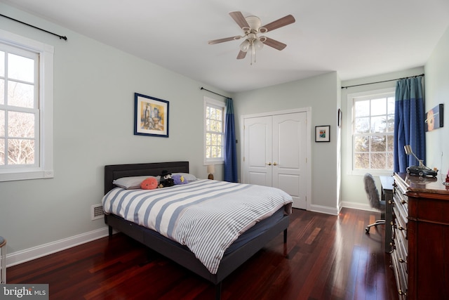 bedroom with a closet, baseboards, ceiling fan, and wood finished floors