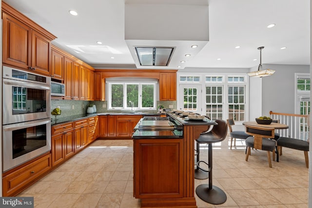 5325 Sandy Point Ln, Clifton, VA 20124 - kitchen with stainless steel appliances, backsplash, plenty of natural light, dark countertops, and recessed lighting