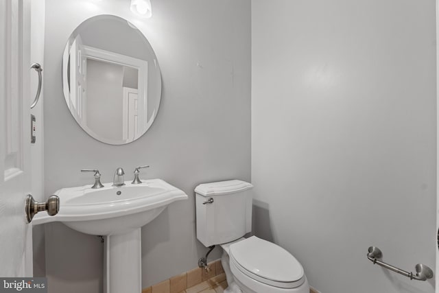 5325 Sandy Point Ln, Clifton, VA 20124 - bathroom with toilet, baseboards, a sink, and tile patterned flooring