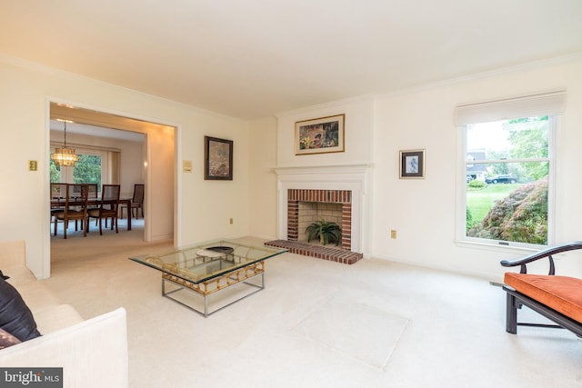 living room with ornamental molding, carpet floors, healthy amount of natural light, and a chandelier
